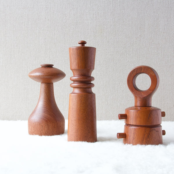 A group of mid-century modern Danish teak pepper mills by Jens Quistgaard for Dansk Designs, Denmark, including UFO, Queen and Anchor designs.
