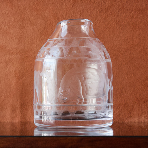 A rotund barrel shaped muscular beast engraved by hand into an organically shaped crystal clear vase. Both the idiosyncratically shaped vase and engraved scene designed by Scandinavian designer Erik Höglund. 