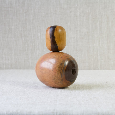 A small plumber's bobbin stood atop a larger bobbin. These antique tools were used for mending lead pipes. Today they are beautiful sculptural display pieces that evoke the work of famous mid century Modernists such as Barbara Hepworth and Henry Moore.