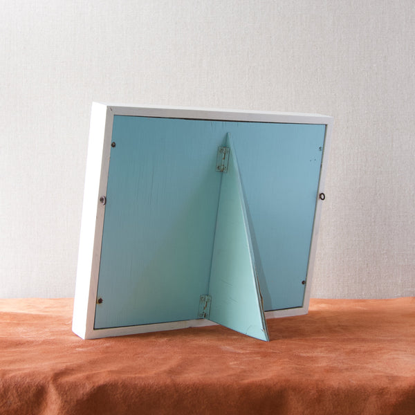 Reverse of free-standing framed sample board by Noelite ltd, the back of the frame and fin are painted in blue which could be called either duck egg or baby-blue