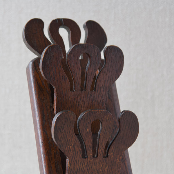 Detail showing the art nouveau inspired arts and crafts design carved into an oak letter rack.