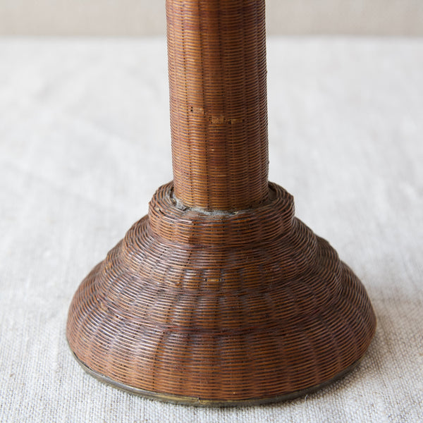 The base of an antique candlestick which has been covered in tiny cane rattan wicker by an expert craftsman in the late-1700s early-1800s. 