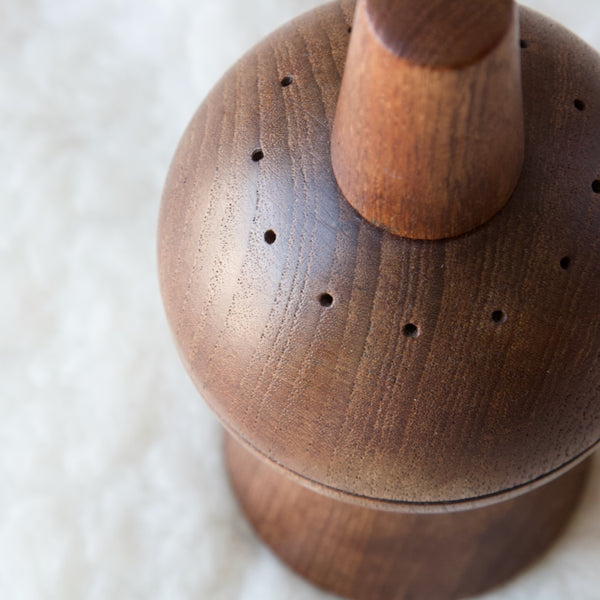 Aerial view showing the salt shaker holes in this carved solid teak Jens Quistgaard combination salt and pepper mill shaker.