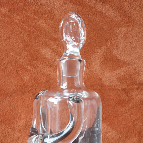 Detail of pressed face on iconic glass decanter in the shape of a person, designed by Erik Höglund
