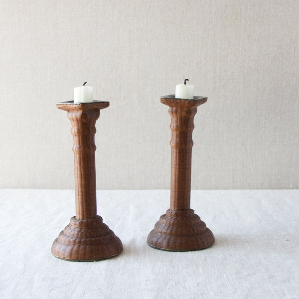 A pair of slightly wonky 18th century candlesticks wrapped in tiny cane wicker. The base of the objects is pewter which is a soft metal which explains why the candlesticks are somewhat wonky.