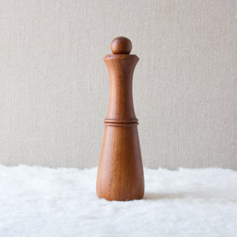 A tall carafe shaped pepper mill designed by Jens Quistgaard for Dansk Designs Ltd 