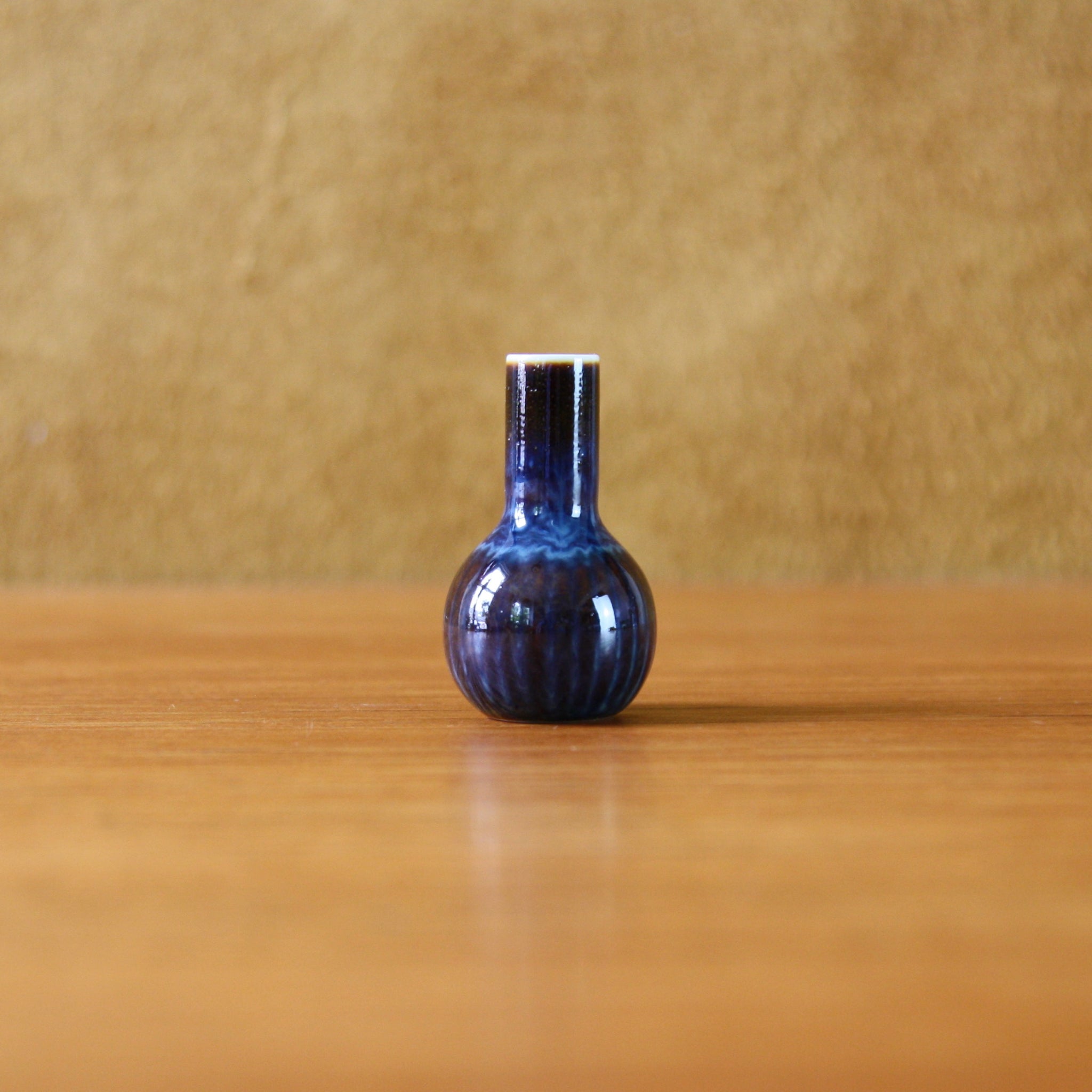 A mid 20th century miniature vase with brown and blue glaze