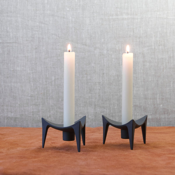 Mid Century Modernist Jens Quistgaard Dansk Designs Tripod cast iron triangular candle holders with lit dinner candles