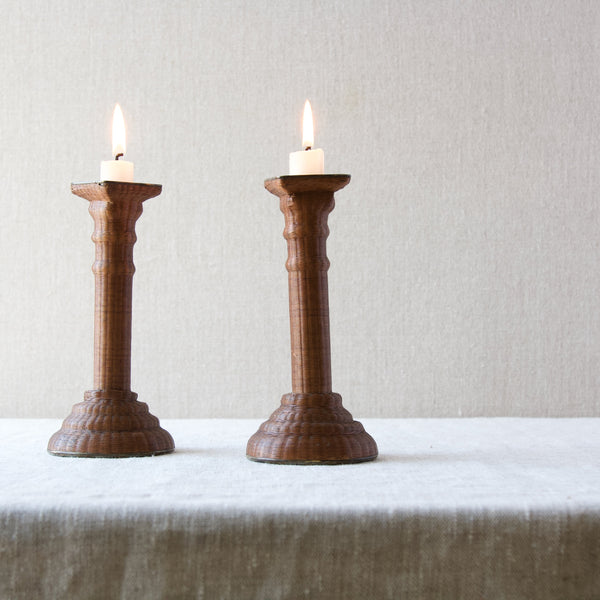 A pair of elegant expertly made wickerwork candlesticks available to buy online at Art & Utility, London. Worldwide shipping available on all items.