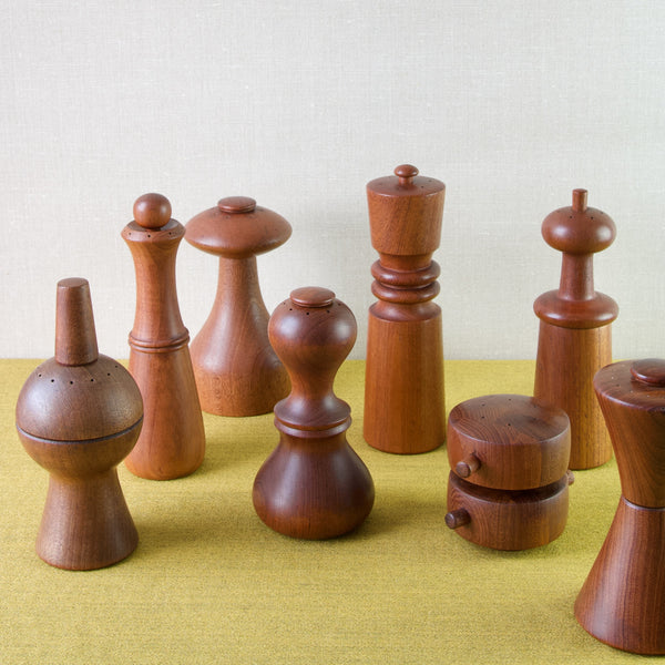 Group shot of a group of 8 Jens Harald Quistgaard combination salt & pepper mills that were designed for the company Dansk Design Ltd founded by Martha and Ted Nierenberg in the early 1950s.