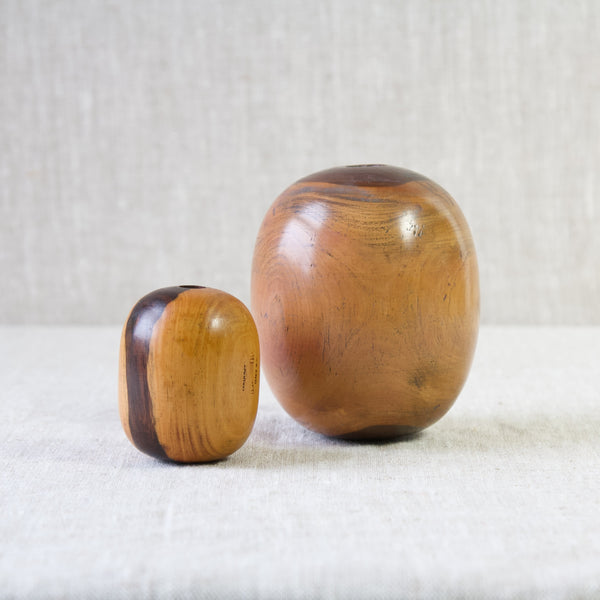 A none matching pair of early twentieth century plumber's bobbins made from lignum vitae. The pleasing egg shape of these objects makes them lovely desk accessories. 