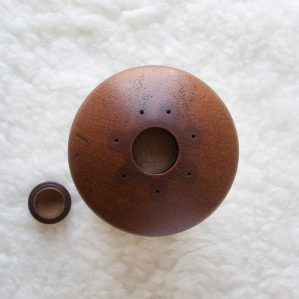Aerial image showing the plug stopper removes from a Dansk Designs pepper mill designed by Jens Quistgaard. This combination salt and pepper mill is nicknamed the "Mushroom" by some and the "UFO" by others. This early example of this classic mid-century Danish design available to buy from Art & Utility South West London.