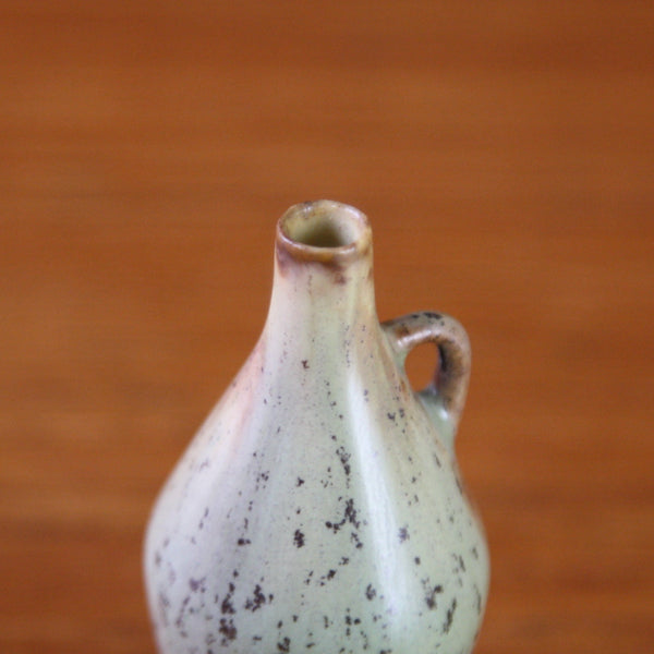 detail of the mouth of a miniature green Rorstrand vase by Carl Harry Stalhane