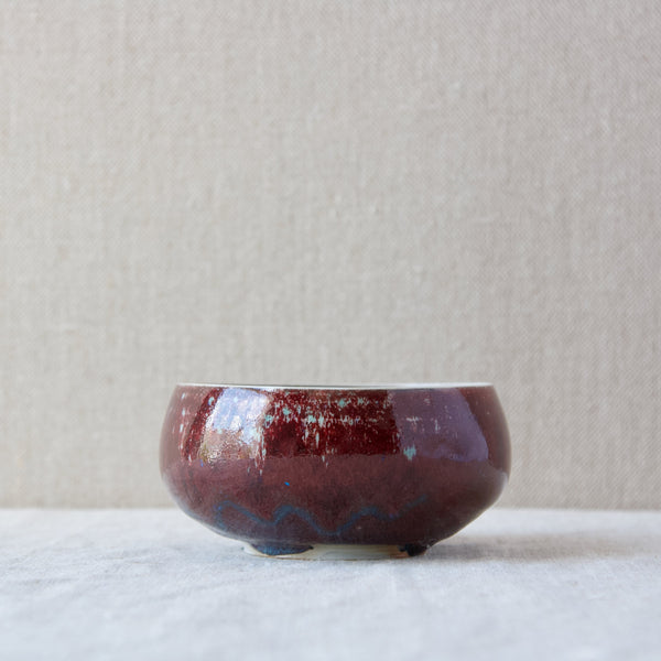 A sang de boeuf ceramic bowl by Carl Harry Stalhane complete with its hand-signed certificate with information written that supports the notion that the bowl was the result of an experiment.