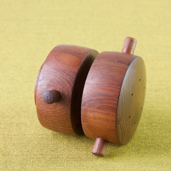 Detail of teak grain wood on a barrel shaped vintage pepper mill designed by Jens Quistgaard for Dansk Designs, Denmark