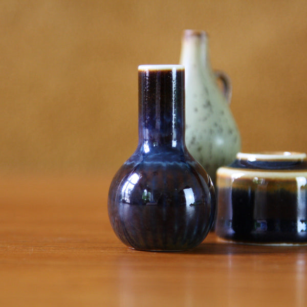 Three miniature vases from Rorstrand, Sweden, focussing on a brown vase with blue striped glaze