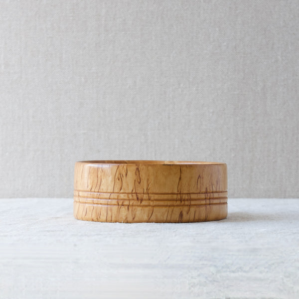 Head on view of a solid Karelian birch bowl that was handmade in Sweden, circa 1960.