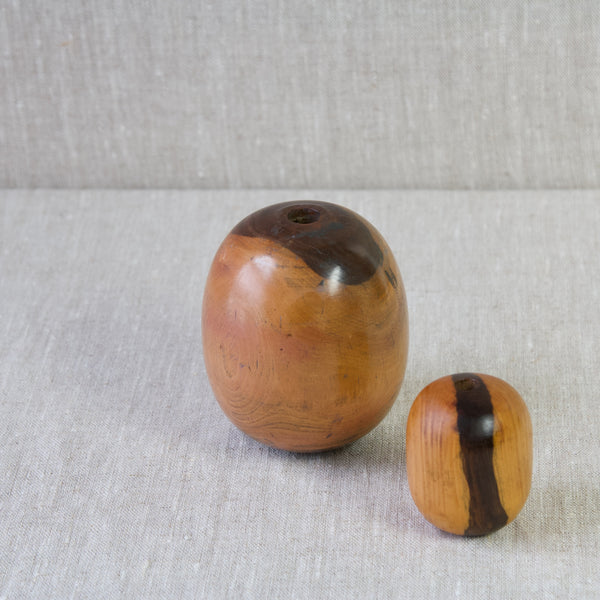 Aerial shot looking down on two lignum vitae plumber's bobbins. The shape of the objects are very pleasing to the eye and the naturally oily wood is extremely tactile.