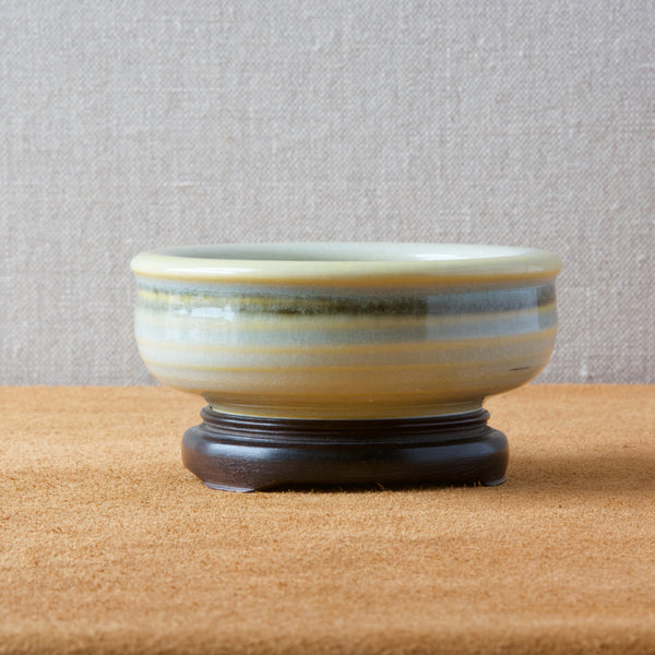 Olle alberius celadon yellow bowl on a chinese wooden stand or plinth